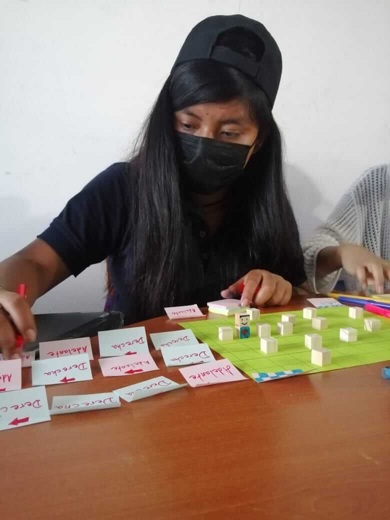 One girl making a board game to learn programming basics.